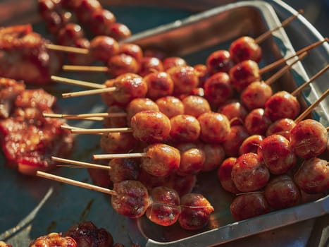 Thai street food in market. Isaan sausages.