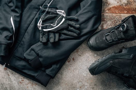Workwear for craftsman with jacket, safety footwear, gloves and goggles