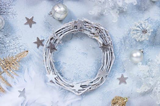 Making Christmas wreath with assorted ornaments, balls in white and silver color
