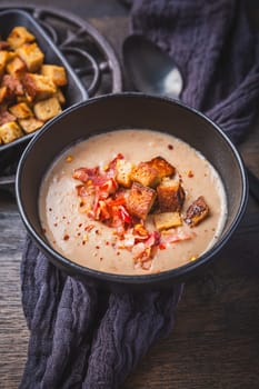Homemade sweet chestnut soup with bacon and bread croutons