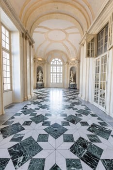 Venaria Reale, Italy - January 2023: luxury interior old royal palace. Gallery perspective with window