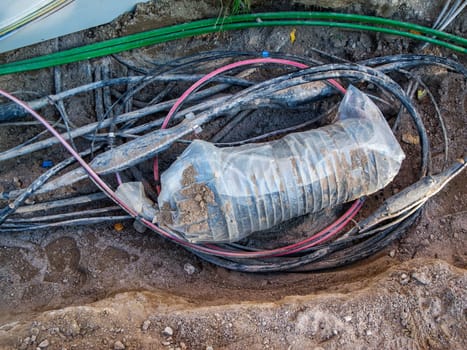 Vertical view of a tangle of cables in a construction pit.