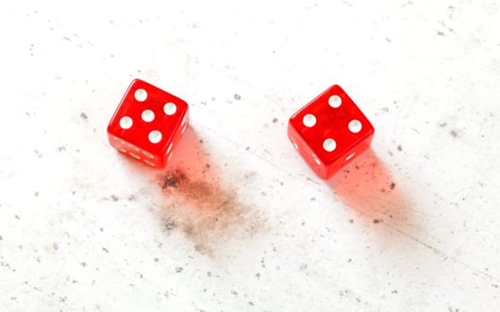 Two red craps dices showing Centerfield Nine (Nina) (number 5 and 4) overhead shot on white board