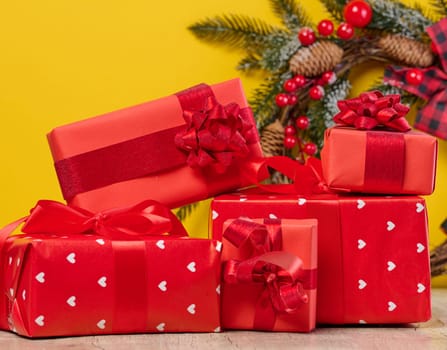 Stack of red gift boxes on yellow background