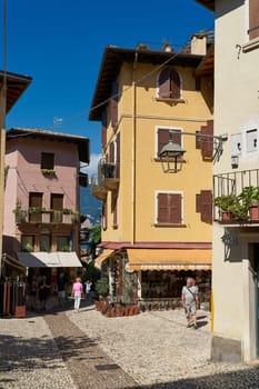 Tourists in the alleys of the popular old town of Malcesine on Lake Garda in Italy