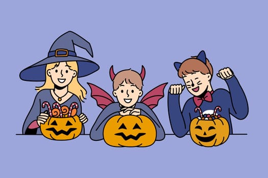 Little children in halloween attire hold pumpkins with treats and smile, rejoicing in coming of october 31st holiday. Boys and girls prepare to celebrate halloween or collect treats from neighbors