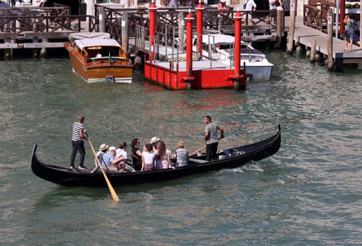 Venice, Italy - September 5, 2022: Tourists during a Gondola cruise on the Grand Canal in Venice. Italy