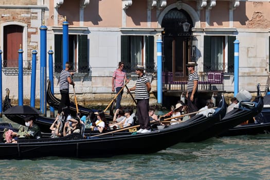 Venice, Italy - September 5, 2022: Tourists during a Gondola cruise on the Grand Canal in Venice. Italy