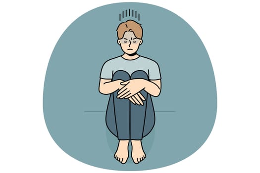 Unhappy young man sitting on floor suffer from loneliness or depression. Upset sad guy struggle from solitude or bad mood. Vector illustration.