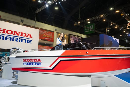 Nonthaburi, Thailand - APR 2, 2023 Unidentified model poses with a boat at The 44th Bangkok international motor show 2023 at IMPACT Arena, Muang Thong Thani, Nonthaburi, Thailand.
