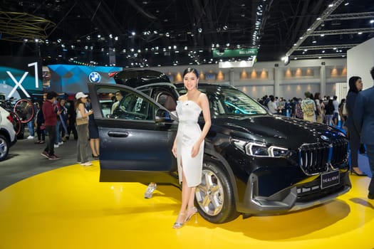 Nonthaburi, Thailand - APR 2, 2023 Unidentified model poses with a car at The 44th Bangkok international motor show 2023 at IMPACT Arena, Muang Thong Thani, Nonthaburi, Thailand.