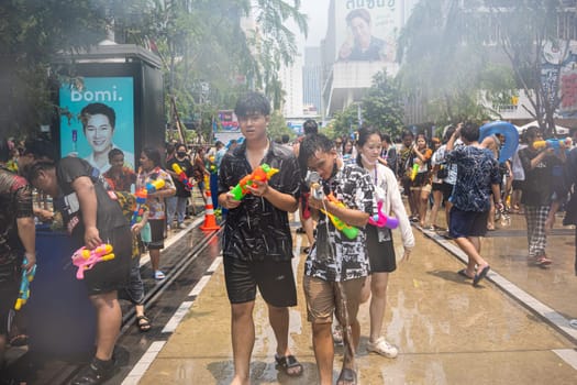 Siam Square, Bangkok, Thailand - APR 13, 2023 Songkran Festival, The short action of people joins celebrations of the Thai New Year or Songkran in Siam Square Bangkok, Thailand.