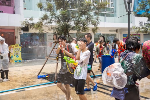 Siam Square, Bangkok, Thailand - APR 13, 2023 Songkran Festival, The short action of people joins celebrations of the Thai New Year or Songkran in Siam Square Bangkok, Thailand.