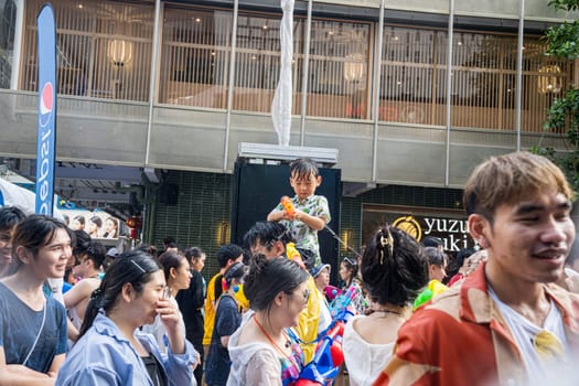 Siam Square, Bangkok, Thailand - APR 13, 2023 Songkran Festival, The short action of people joins celebrations of the Thai New Year or Songkran in Siam Square Bangkok, Thailand.
