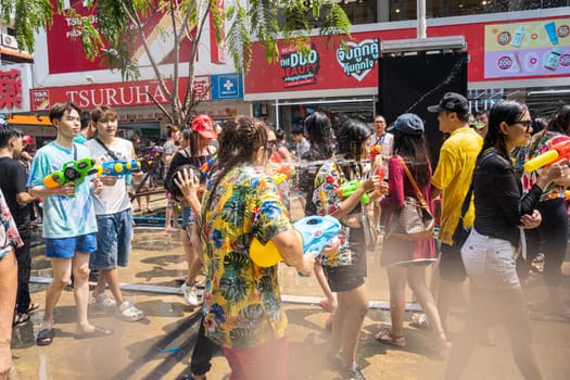Siam Square, Bangkok, Thailand - APR 13, 2023 Songkran Festival, The short action of people joins celebrations of the Thai New Year or Songkran in Siam Square Bangkok, Thailand.