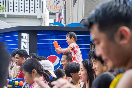 Siam Square, Bangkok, Thailand - APR 13, 2023 Songkran Festival, The short action of people joins celebrations of the Thai New Year or Songkran in Siam Square Bangkok, Thailand.