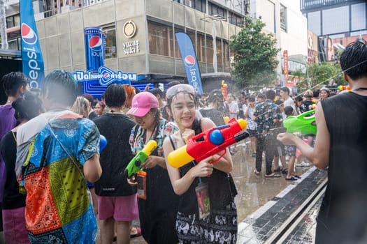 Siam Square, Bangkok, Thailand - APR 13, 2023 Songkran Festival, The short action of people joins celebrations of the Thai New Year or Songkran in Siam Square Bangkok, Thailand.