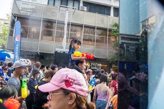 Siam Square, Bangkok, Thailand - APR 13, 2023 Songkran Festival, The short action of people joins celebrations of the Thai New Year or Songkran in Siam Square Bangkok, Thailand.