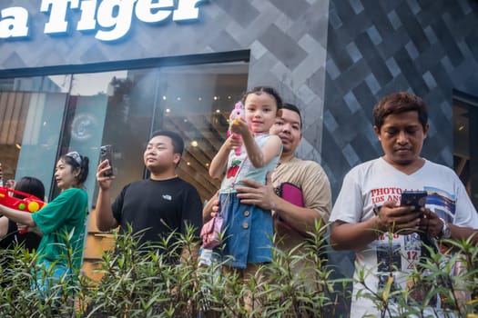 Siam Square, Bangkok, Thailand - APR 14, 2023 Songkran Festival, The short action of people joins celebrations of the Thai New Year or Songkran in Siam Square Bangkok, Thailand.