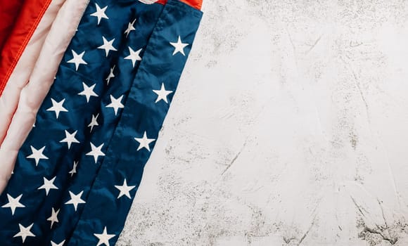 For Veteran's Day, a vintage American flag stands tall, symbolizing honor, unity, and pride in the United States. Patriotic stars and stripes are symbolic. isolated on cement background