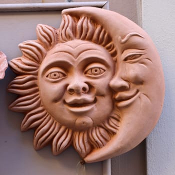 Massa Italy - Sept 11, 2022: Lovely sun and moon couple on the window of a shop with typical Italian ceramics in Massa Maritima. Tuscany, Italy