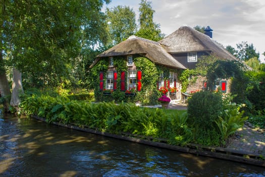 GIETHOORN, NETHERLANDS -typical dutch county side of houses and gardens