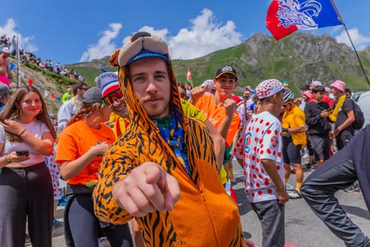 Col du Tourmalet, France - July 06 2023: Cycling fans waiting for the buch at the top of the Col du Tourmalet in Pyerenees mountains during the stage 6 of Le Tour de France 2023