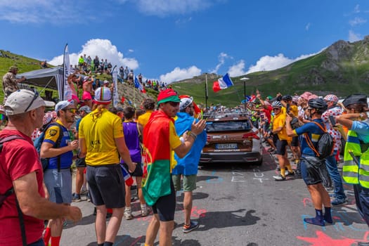Col du Tourmalet, France - July 06 2023: Cycling fans waiting for the buch at the top of the Col du Tourmalet in Pyerenees mountains during the stage 6 of Le Tour de France 2023