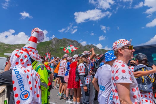 Col du Tourmalet, France - July 06 2023: Cycling fans waiting for the buch at the top of the Col du Tourmalet in Pyerenees mountains during the stage 6 of Le Tour de France 2023
