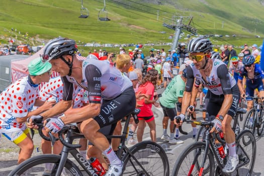 Col du Tourmalet, France - July 06 2023: Emirates Team climbig the road to Col du Tourmalet in Pyerenees mountains during the stage 6 of Le Tour de France 2023.