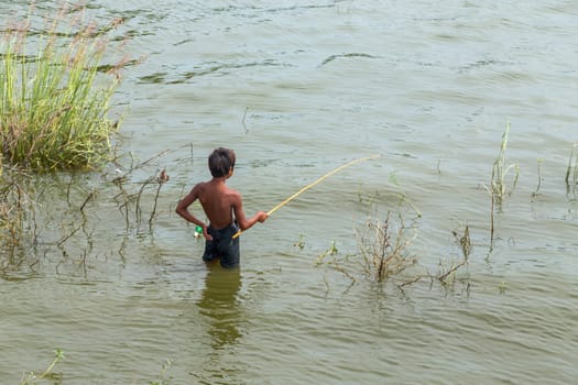 The Inle Lake. Myanmar: 17 August 2020: Young kid fishing in Inle Lake.