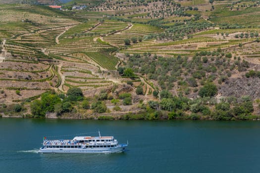 Pinhao, Portugal - August 25, 2023: Boat carrying tourists on the Douro River, Vila Real, Portugal
