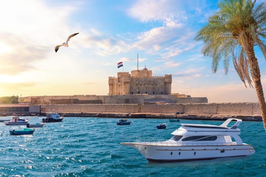 Boat in the Mediterranean in front of Citadel of Qaitbay, Alexandria, Egypt.