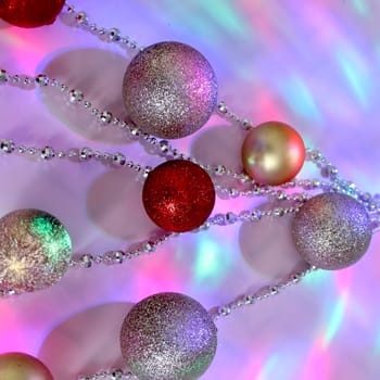 christmas balls on a background of colored lights and bokeh.