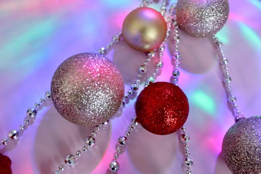 christmas balls on a background of colored lights and bokeh.