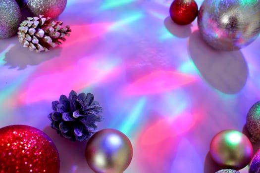 christmas balls on a background of colored lights and bokeh.