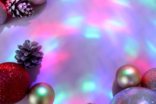 christmas balls on a background of colored lights and bokeh.