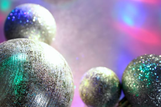 christmas balls on a background of colored lights and bokeh.