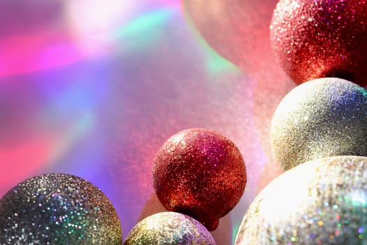 christmas balls on a background of colored lights and bokeh.