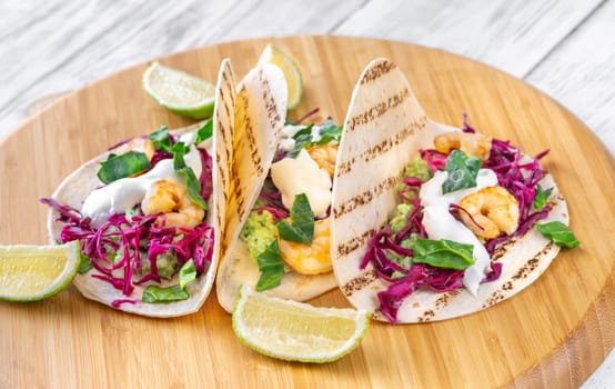 Tacos with shrimp, red cabbage, guacamole and sour cream