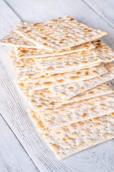 Stack of Matzah on the white wooden background