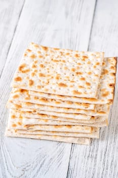 Stack of Matzah on the white wooden background