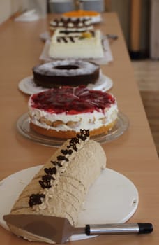 One with various cakes, festively set up dinner table