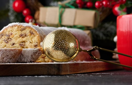 Christmas pastries stollen sprinkled with powdered sugar on the table, festive dessert