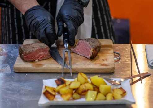 Grilled beef tenderloin on a wooden kitchen board, ready to eat