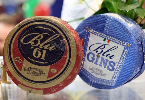 Cracow, Poland - November 17, 2022: Whole wheels of blue mold cheeses at Enoexpo and Gastrofood - Trade Fair for Food and Drinks for Catering