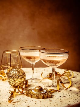 Happy New Year celebration,  two glasses of champagne, streamers and ornaments