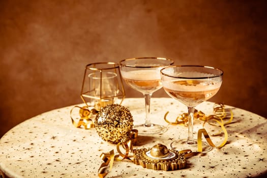 Happy New Year celebration,  two glasses of champagne, streamers and ornaments