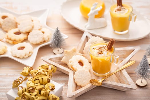 Homemade eggnog, egg liqueur for Christmas with small cookies