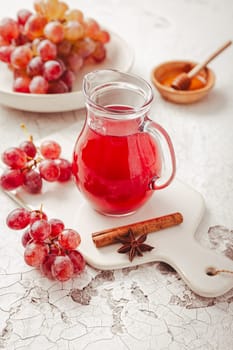 Homemade organic red vinegar with cinnamon and anise. Red grape balsamic vinegar made from fermented fresh grapes.